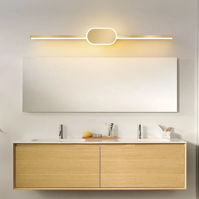 Modern bathroom mirror cabinet with LED vanity lights and a gold-toned frame.