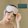 Green portable eye SPA mask with suede exterior on a white background.