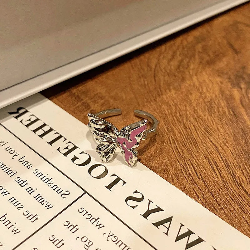 Copper women's ring with butterfly design, showing dripping oil finish surface texture