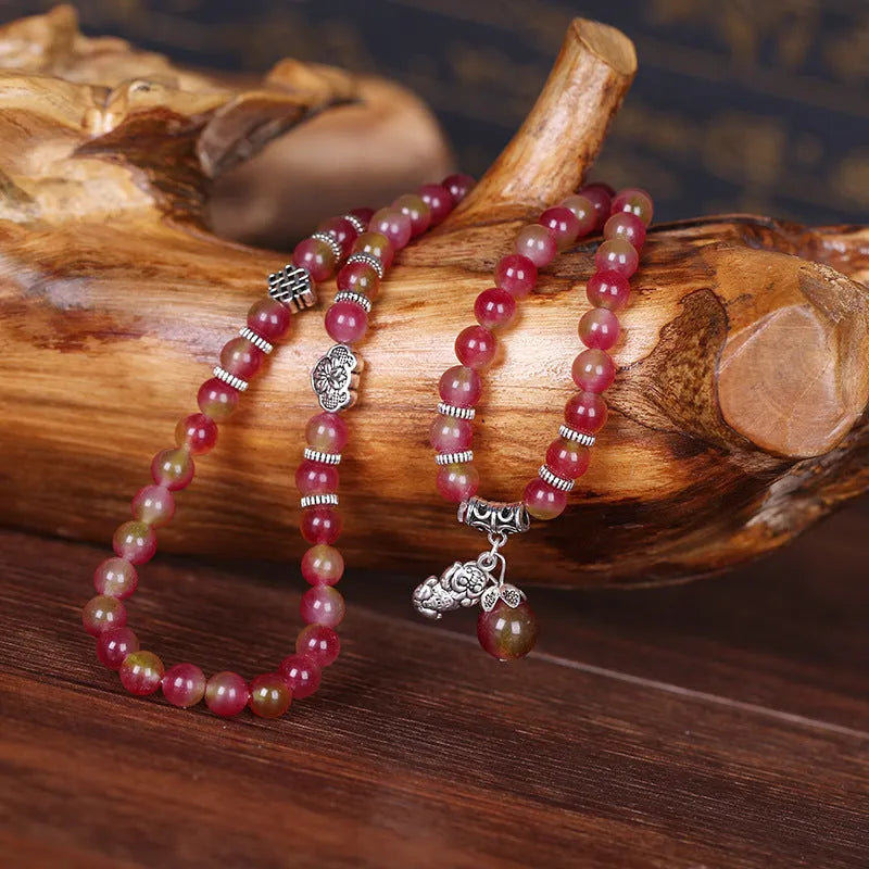 Handmade geometric bracelet made from natural watermelon crystal beads with a traditional Chinese knot clasp.