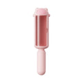 Blue reusable pet hair removal roller with self-cleaning base on a fabric sofa.