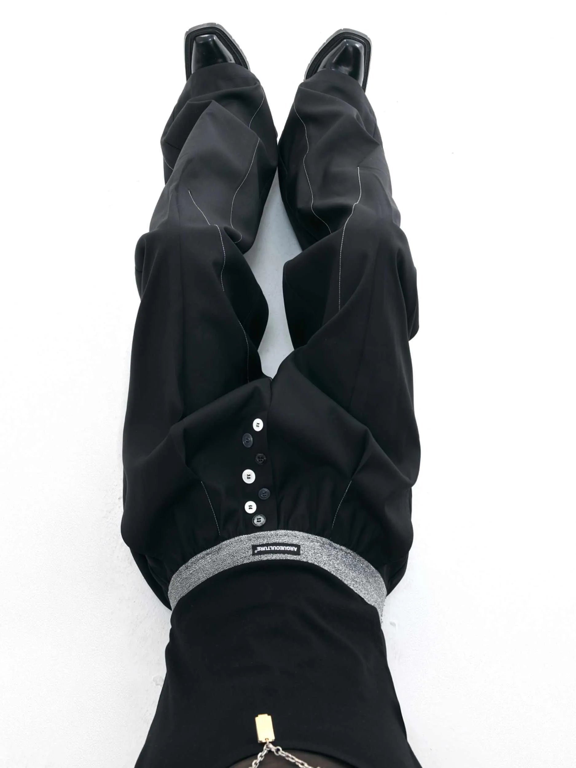 Drooping straight-leg high-waisted casual trousers with button detail in black and grey.
