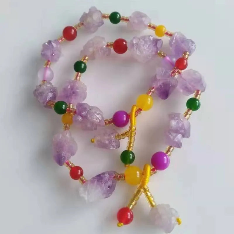 Close-up of a natural-shaped amethyst bead bracelet for women with a fu charm.