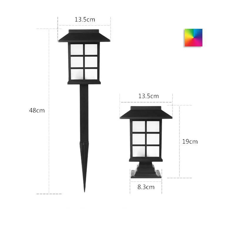 Black solar outdoor LED lawn light with decorative windows, IP65 waterproof, placed in a garden