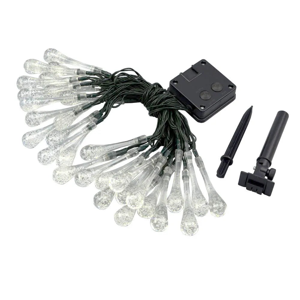 6.5 metre long solar-powered LED garden string lights with white bubble drop shaped lamps on a green lawn
