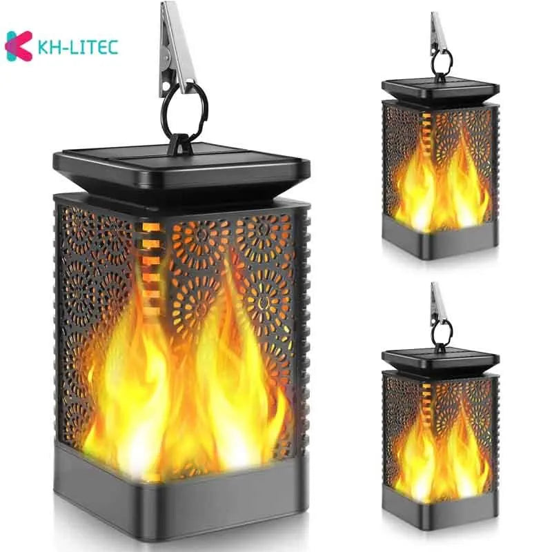Black solar-powered LED hanging torch light with flickering flame effect for outdoor garden decoration.