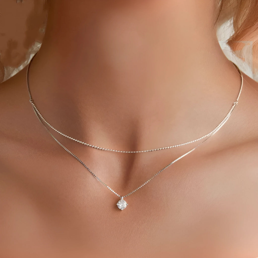 Silver double-layer necklace with pearl chain and sterling silver pendant.