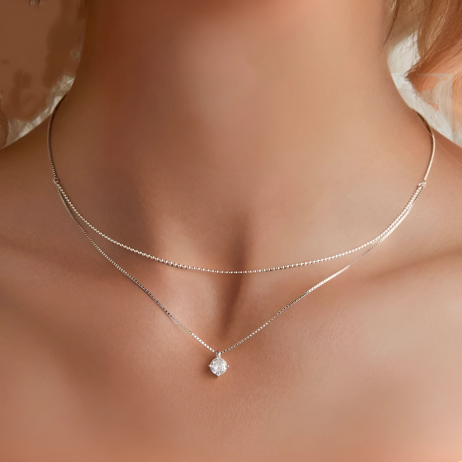 Silver double-layer necklace with pearl chain and sterling silver pendant.