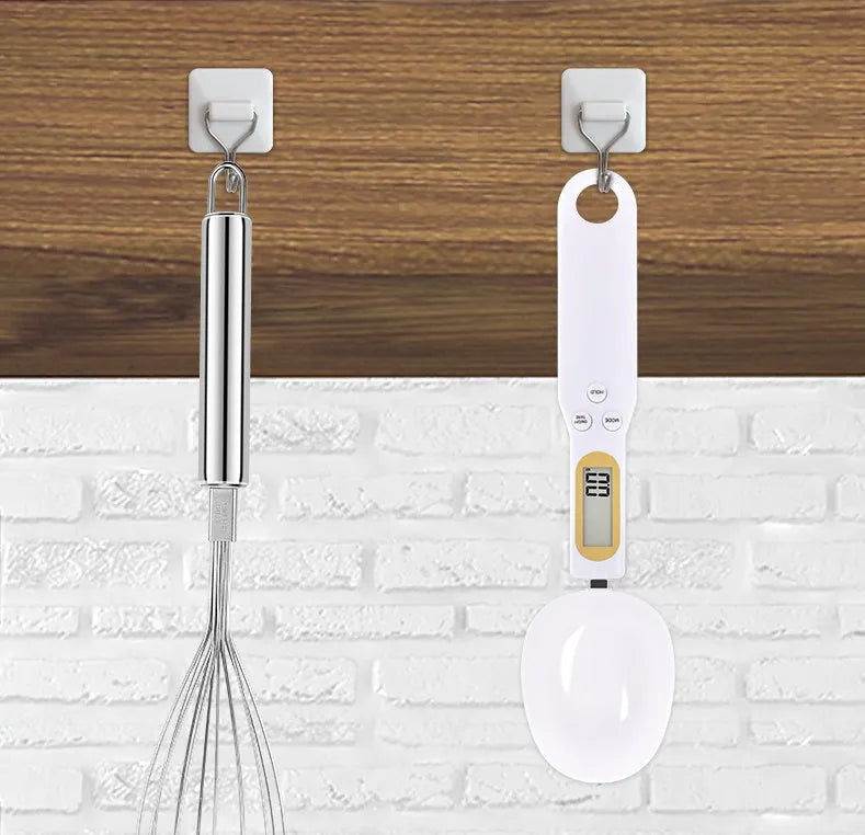 Household electronic measuring spoon scale with ABS plastic body and digital display on a kitchen surface