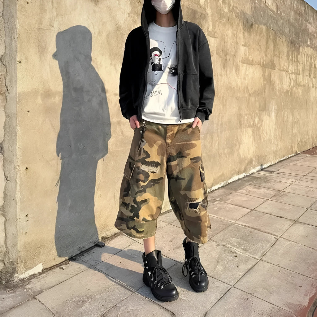 Men's loose-fit camouflage cropped jeans with ripped knees and retro patches on a straight-leg.