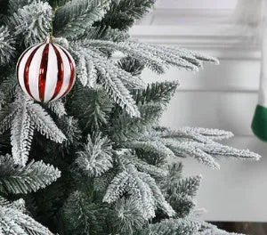 Colourful glass ball hanging ornament on a string against a white background