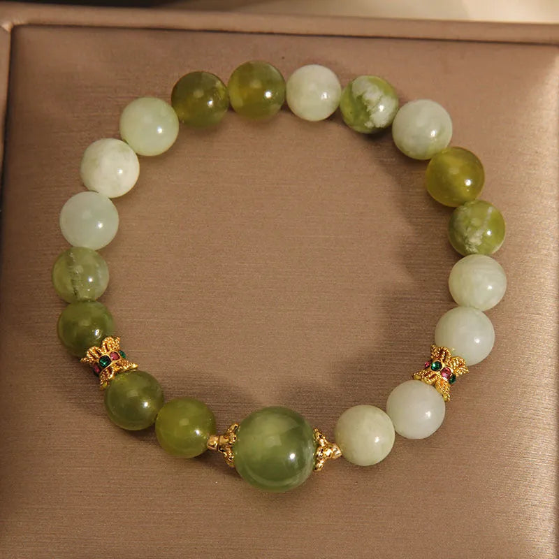 Women's bracelet in Xiuyan jade green with original design on display