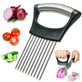Stainless steel onion holder slicer with non-slip base on a kitchen counter next to a tomato and knife