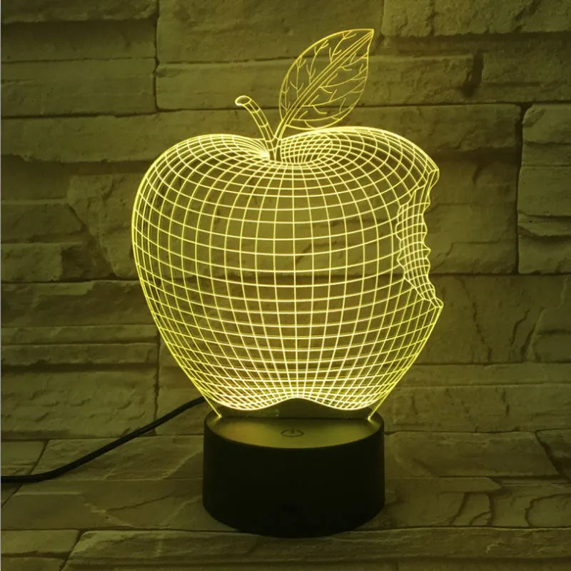 3D fruit-shaped colourful LED night light with touch control on a surface.