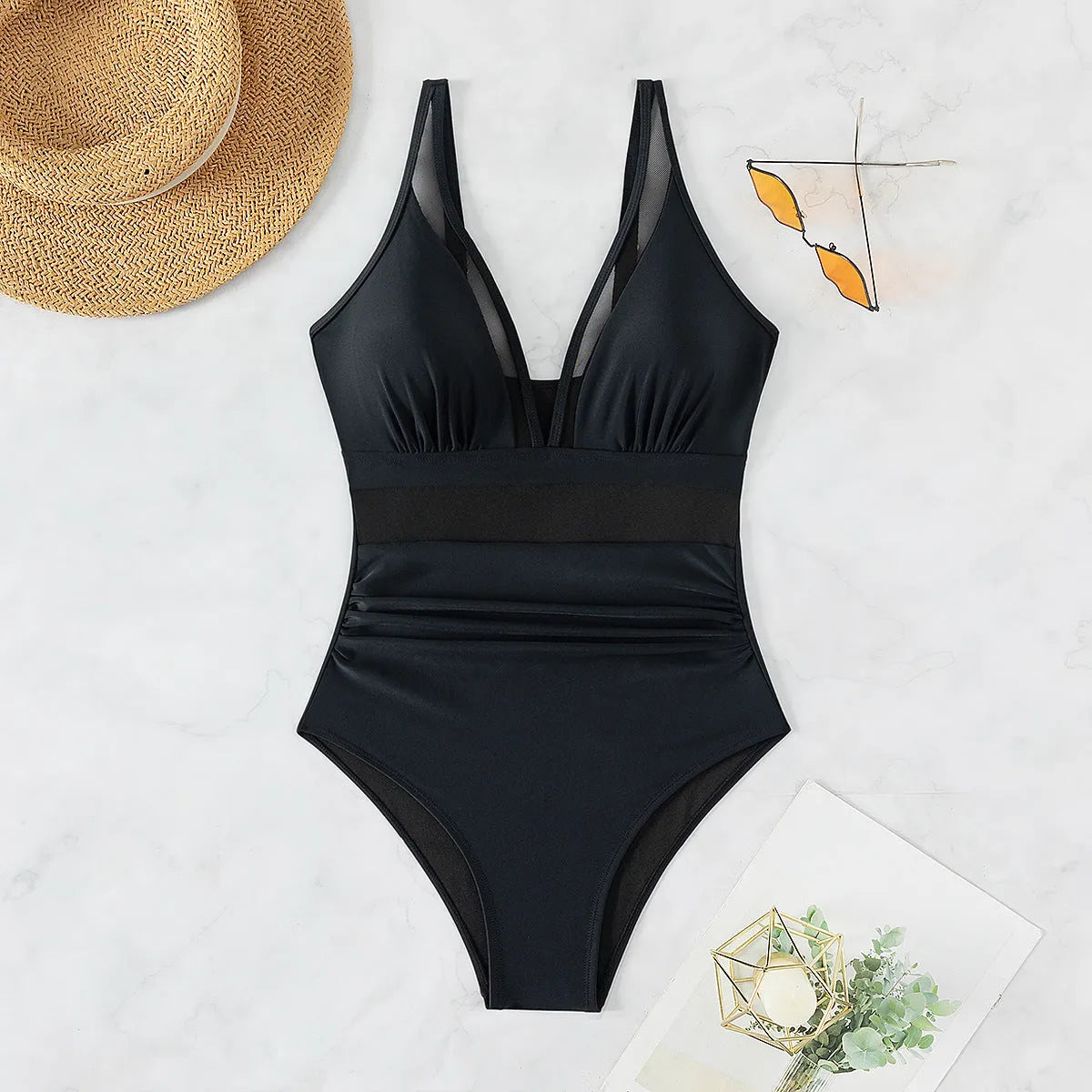 Black women's one-piece swimsuit with halter neck and mesh fabric panelling.