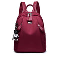 Medium size wine red Oxford cloth rucksack showing internal mobile phone and ID organisation pockets