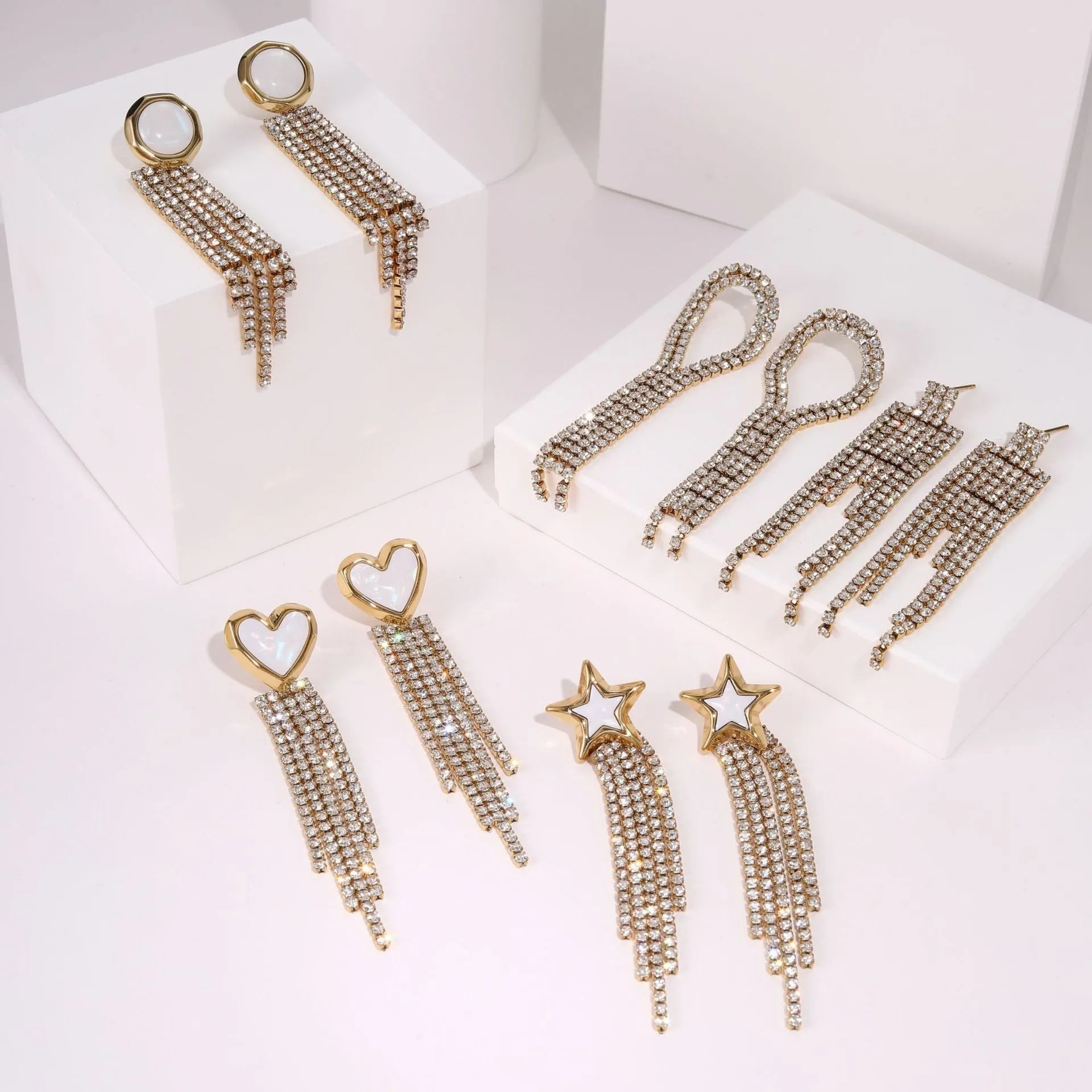 Stainless steel earrings with diamond tassel design in heart or star shapes with electroplated 18K gold finish