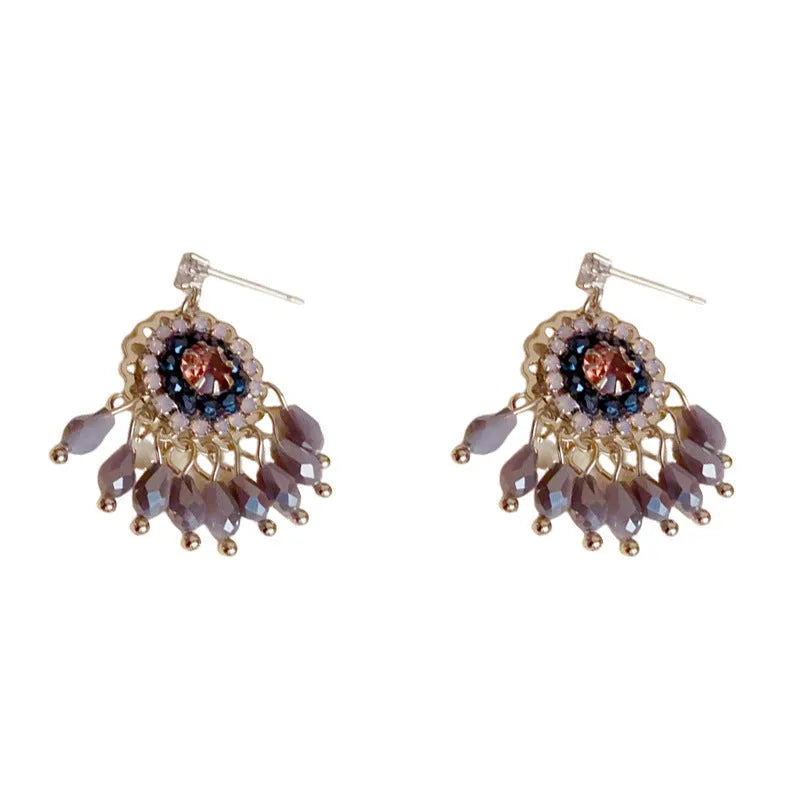 Pair of diamond embedded round crystal tassel earrings, thick gold plated, purple colour, on a white background