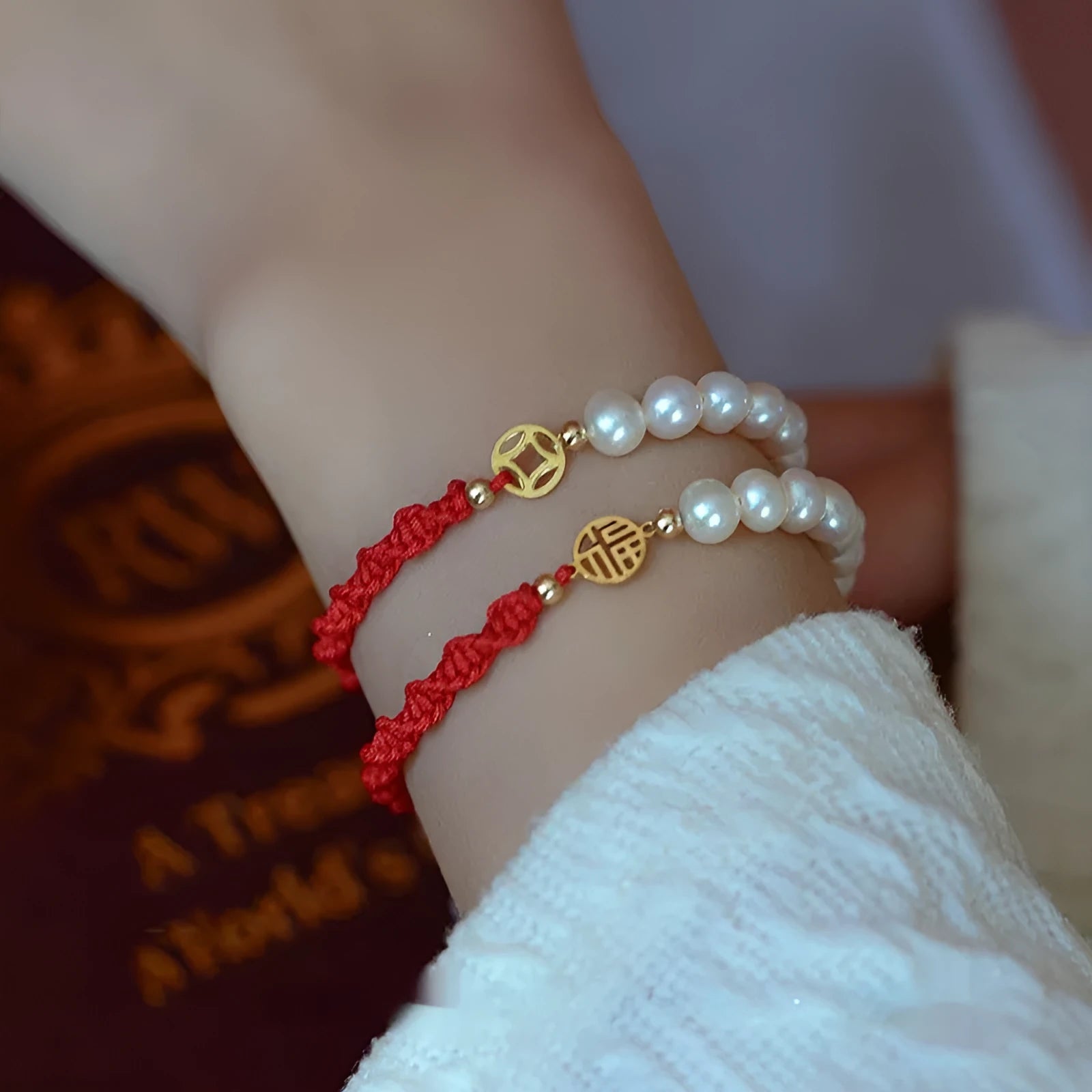 Women's pearl braided red rope bracelet with domestic 14K gold plated fu character charm on red background