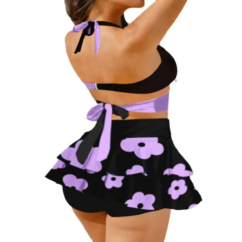 Women's black lace-up bikini with a matching high-waisted split skirt.