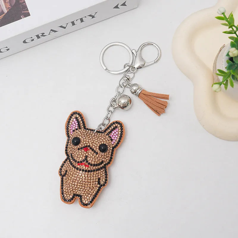 Cartoon French dog rhinestone keychain in alloy with electroplated finish.