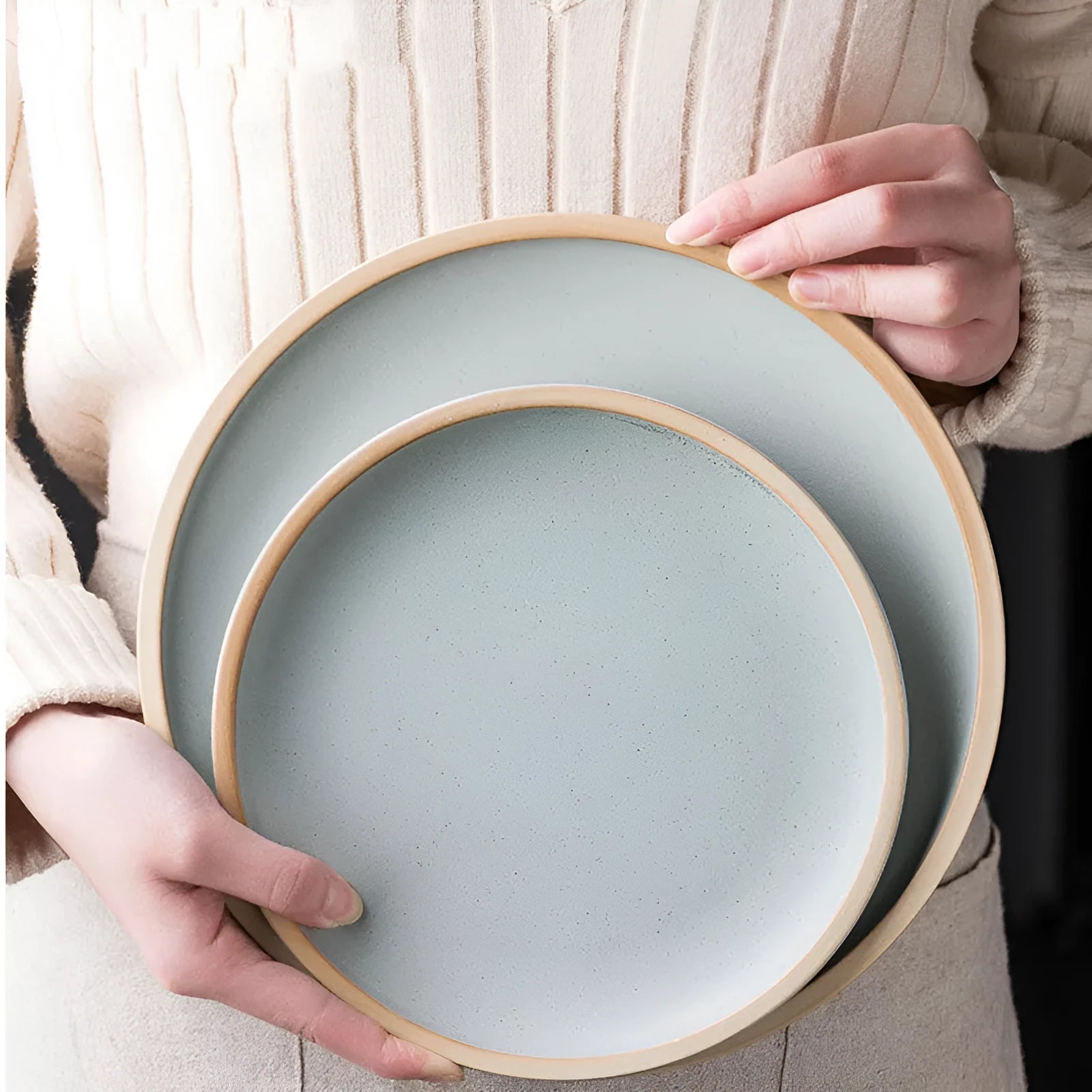 Blue matte ceramic plate with sesame point glaze on a table, 10 inch diameter.