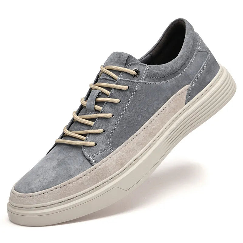 Men's grey low-top casual skate shoes with a pigskin leather upper and rubber sole.