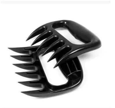 Two black PC plastic bear claw shredders for meat lying side by side on a cutting board