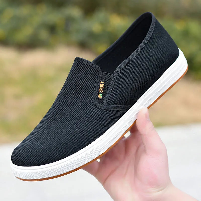 Men's black canvas slip-on shoes with round toe and injection-moulded sole