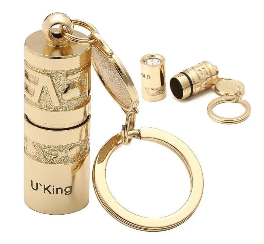 Gold-coloured zinc alloy waterproof mini LED keychain flashlight on a keyring.