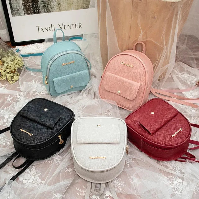 Women's small PU shoulder backpack in solid colour with convertible strap design and zipper closure
