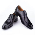 Men's hand carved cowhide Oxford shoes in black with pointed toe and low top design