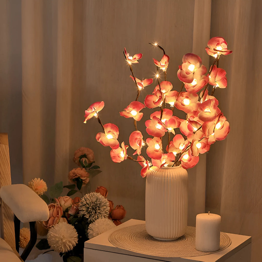 Pink Phalaenopsis branch shaped decorative LED light with 20 warm white lights, powered by batteries.