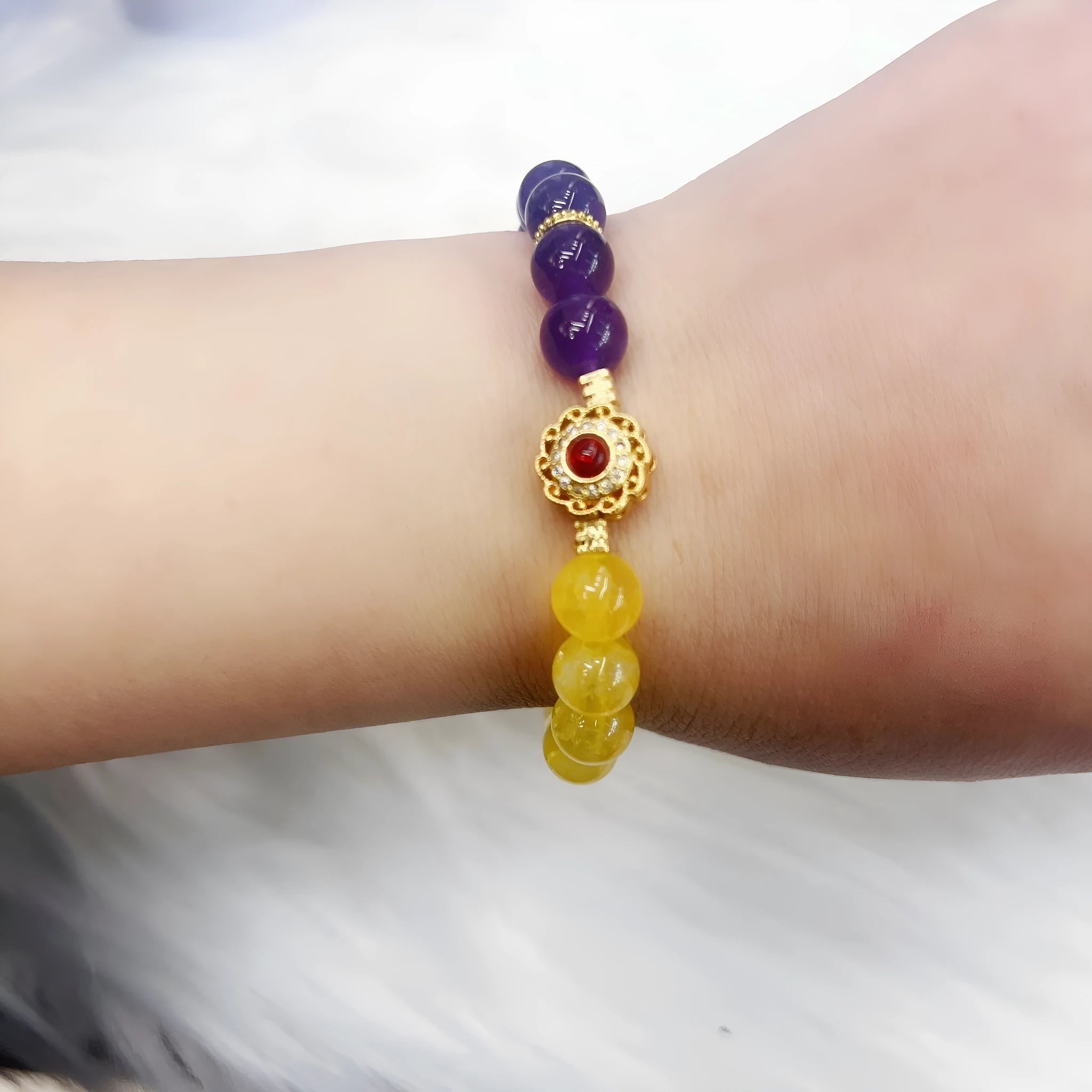 Handmade women's bracelet with yellow and purple amethyst crystal beads