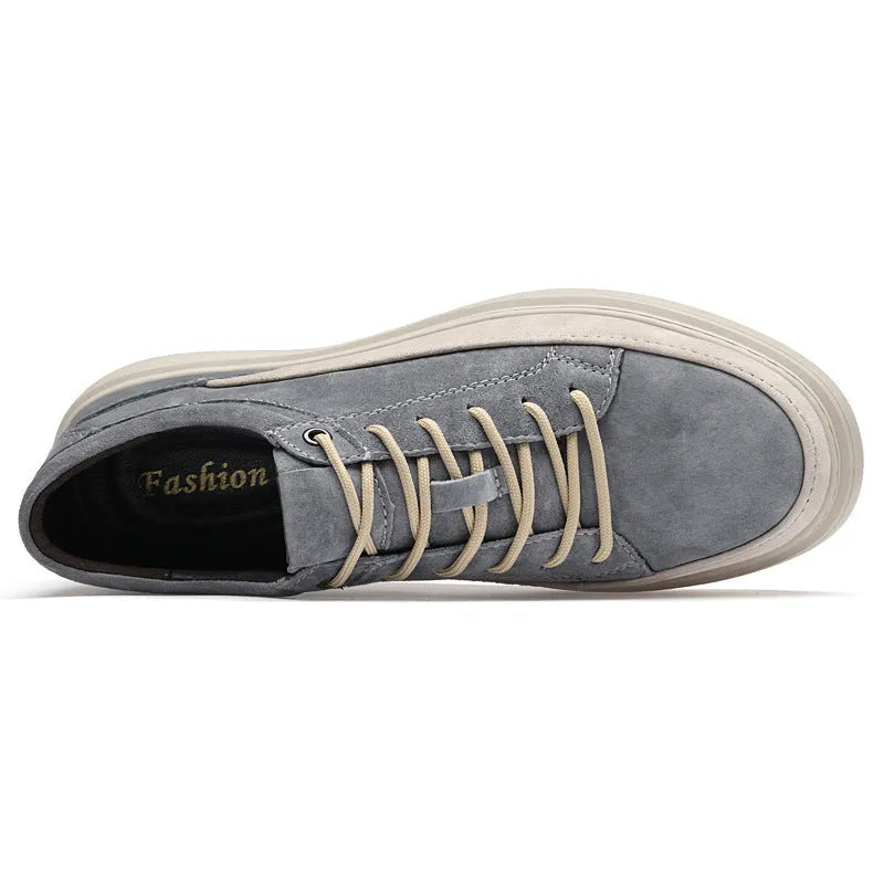 Men's grey low-top casual skate shoes with a pigskin leather upper and rubber sole.