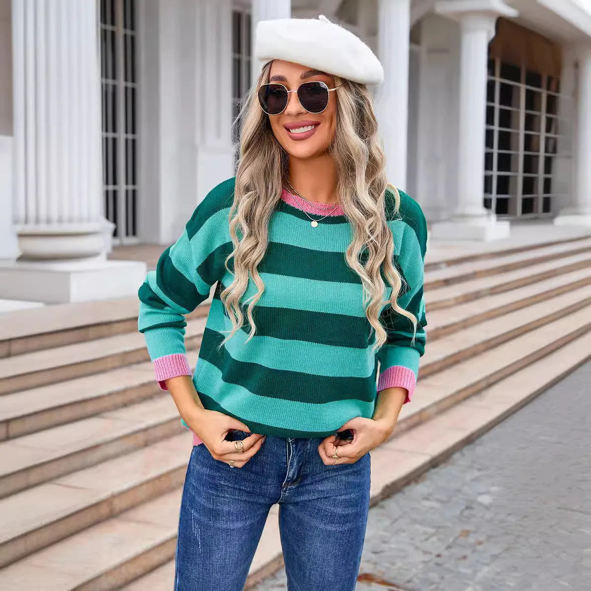 Loose fit women's acrylic sweater with round neck and long sleeves on a hanger