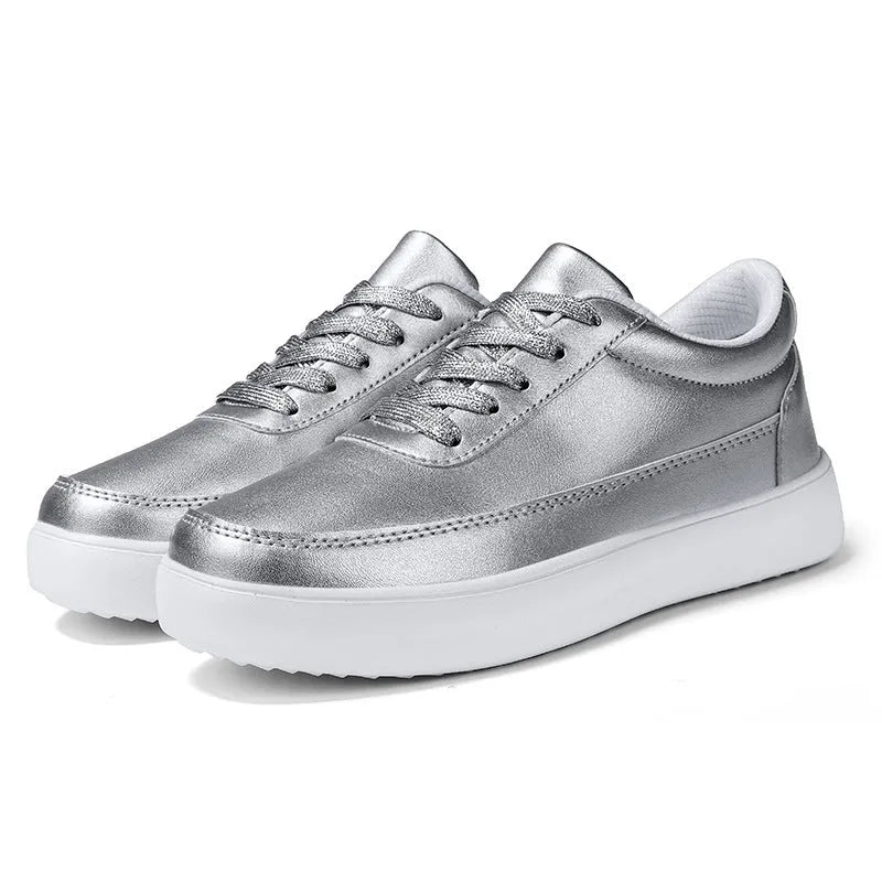 Women's white leather lace-up flat casual shoes shown from the side.