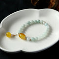 Women's bracelet with 7.5mm round agate beads and hanging tassel in 14K gilded finish