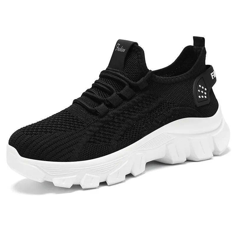 Women's white Flyknit running shoes with a thick PVC sole and lace-up front.
