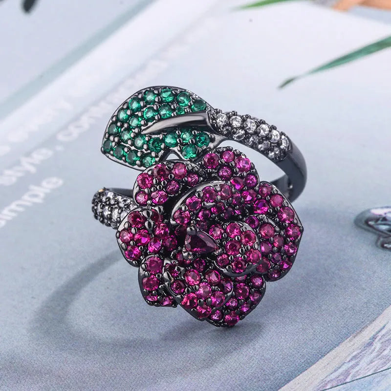 Black gold geometric flower ring with red simulation stones on gold-plated copper band