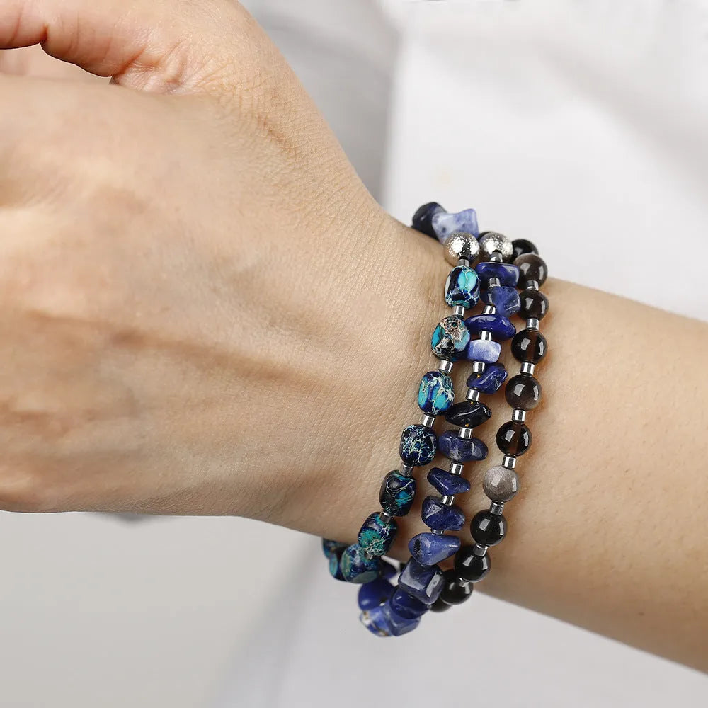 Blue multi-layer hand woven bracelet with Fang Hui stone and gold obsidian geometric texture on white background