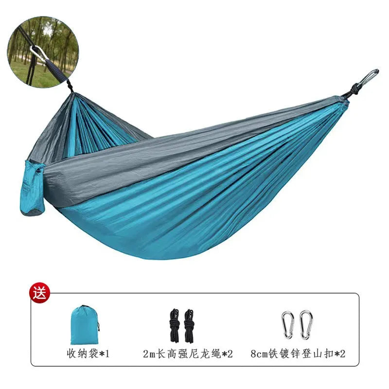 Blue nylon outdoor camping hammock with 300kg load capacity shown suspended between trees