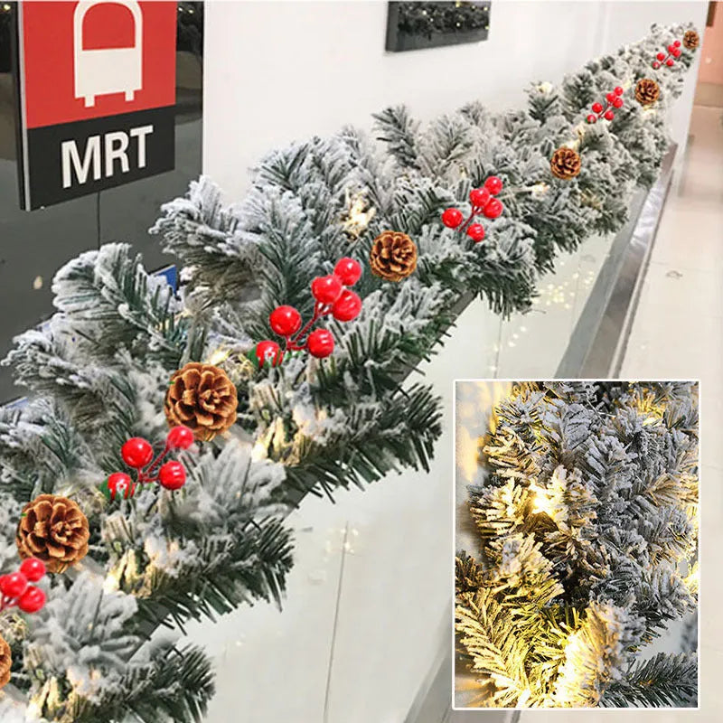 Christmas rattan-style PVC garland with white flocked snow detailing in coiled display