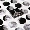 Box of 45 black moon phases and calendar planet stickers on self-adhesive paper