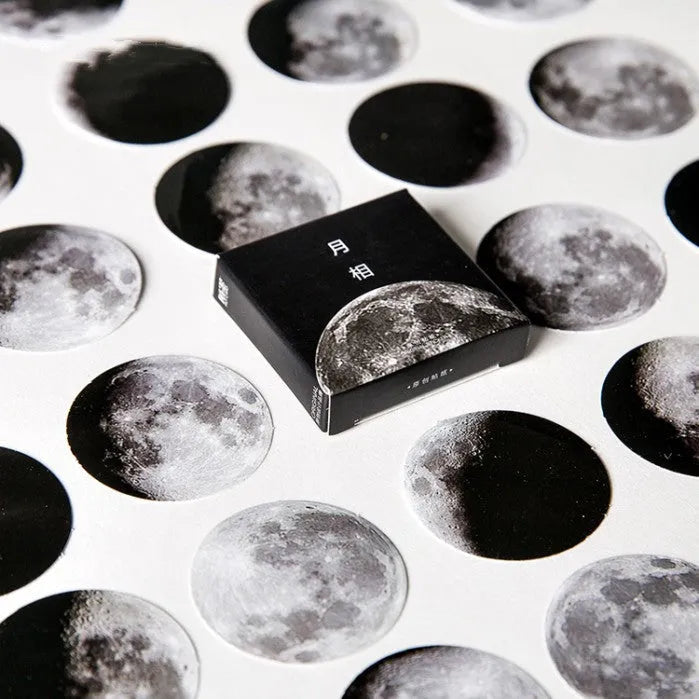 Box of 45 black moon phases and calendar planet stickers on self-adhesive paper