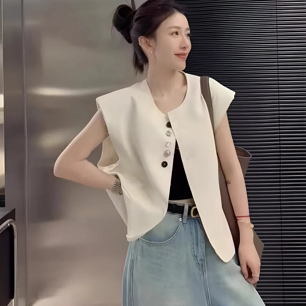 Women's loose fit polyester vest in milky white colour with pockets.