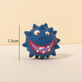 Set of four coloured natural latex squeaky dog balls with cute faces and textured surfaces