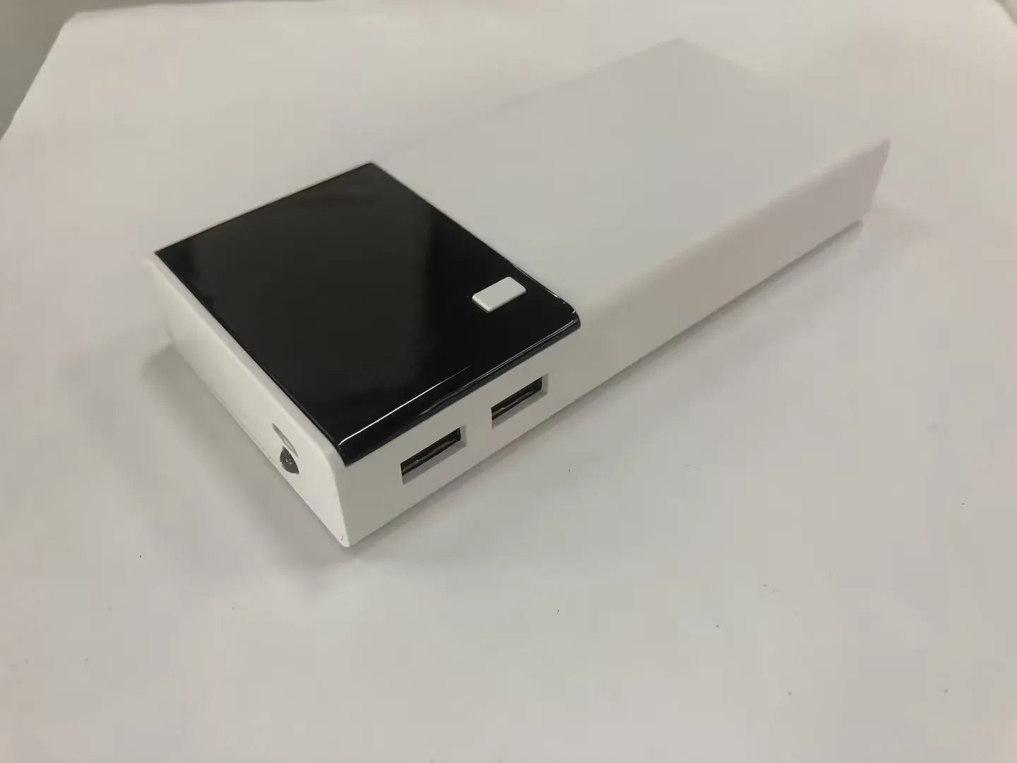 Black 20000mAh power bank with plastic casing showing dimensions of 135mm by 60mm by 20mm