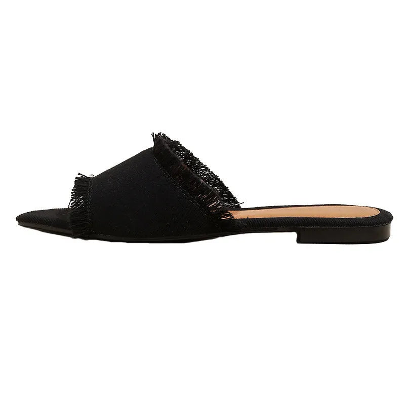 Women's denim flat slippers with tassel detail and leather lining in multiple colour options.