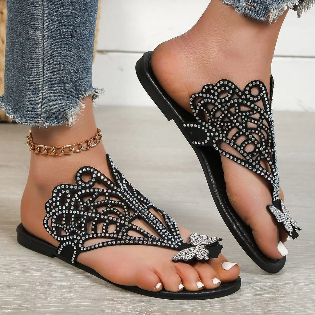 Gold women's slip-on sandals with rhinestone detail on the flip-toe strap and a flat rubber sole.